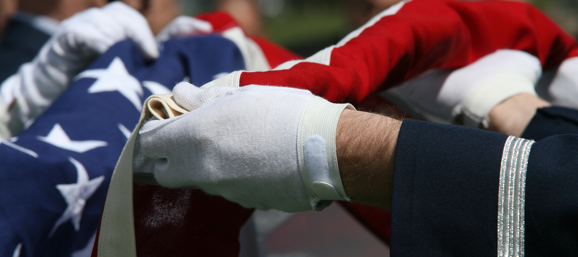 Military servicemen folding the American flag