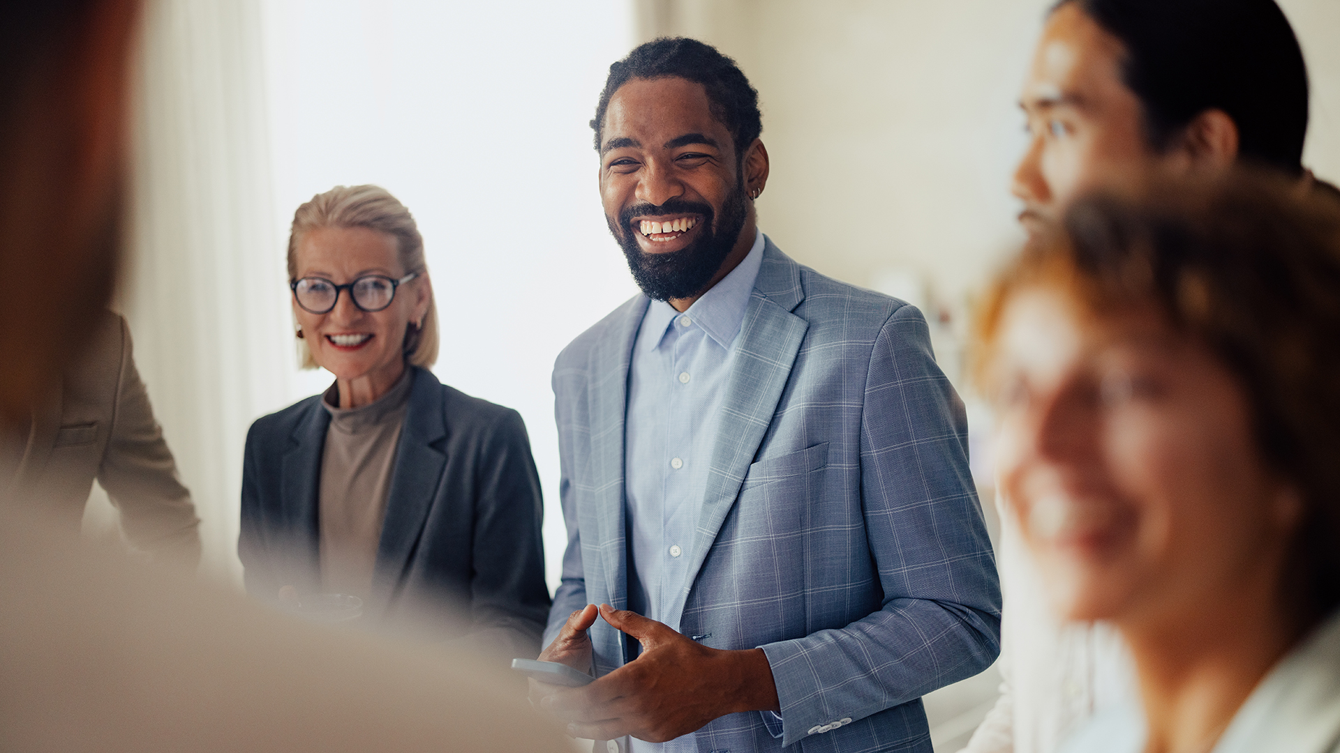 Group of business professional smiling in a room