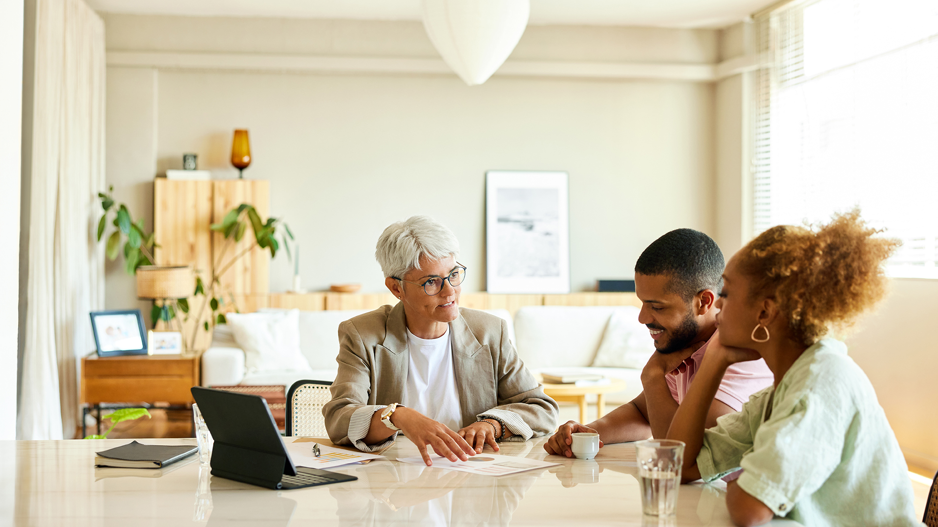 Female financial planner meeting with a married couple in their home