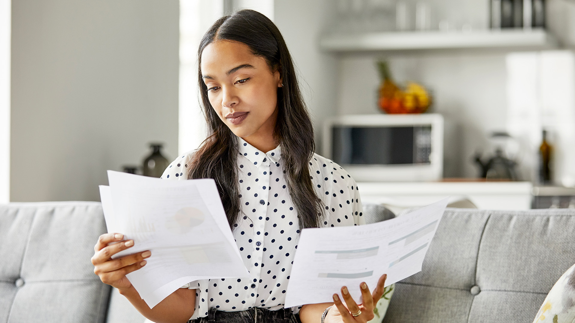 Young female professional reading various reports