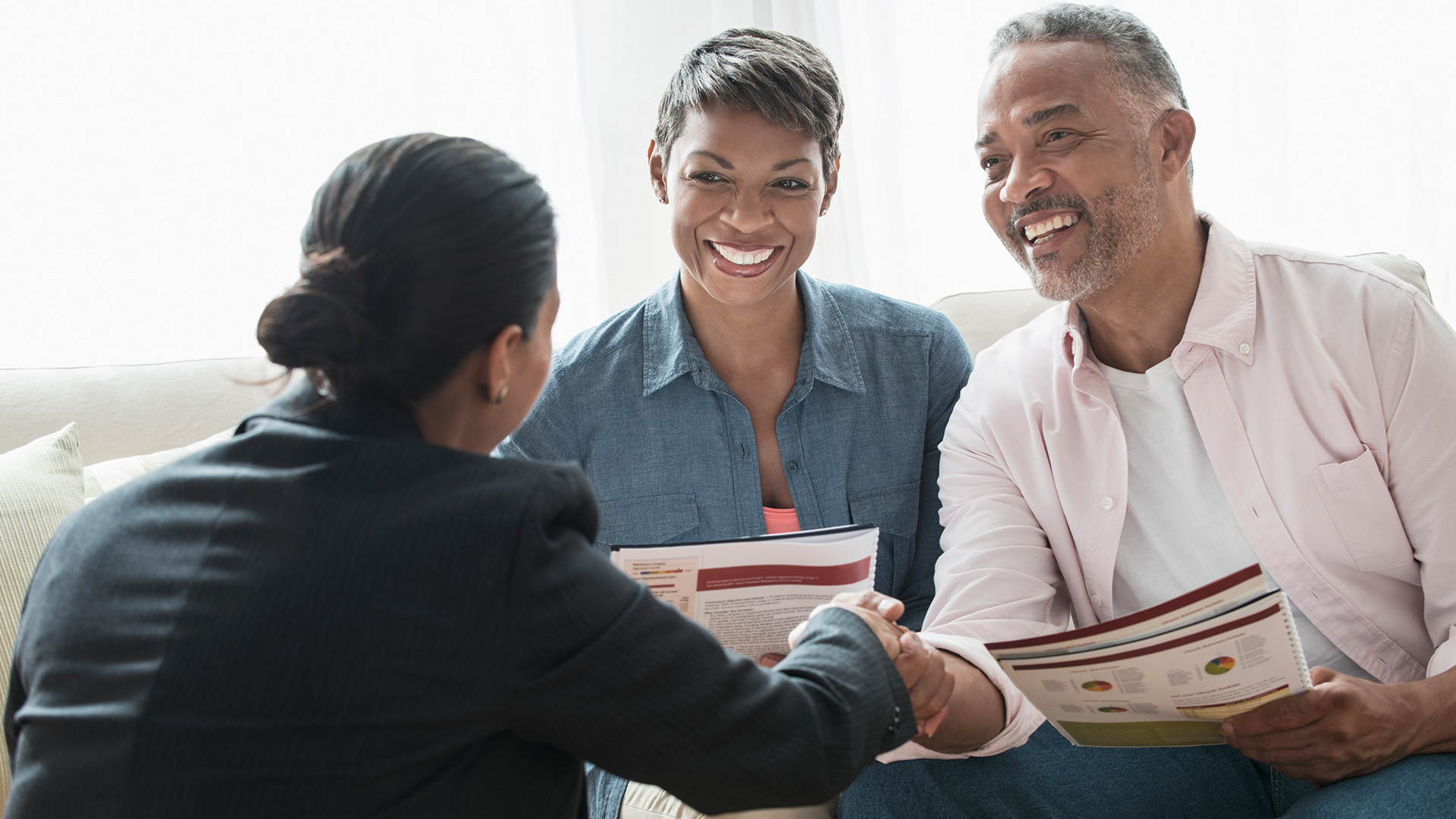 Black couple talking with ethical advisor on their financial options