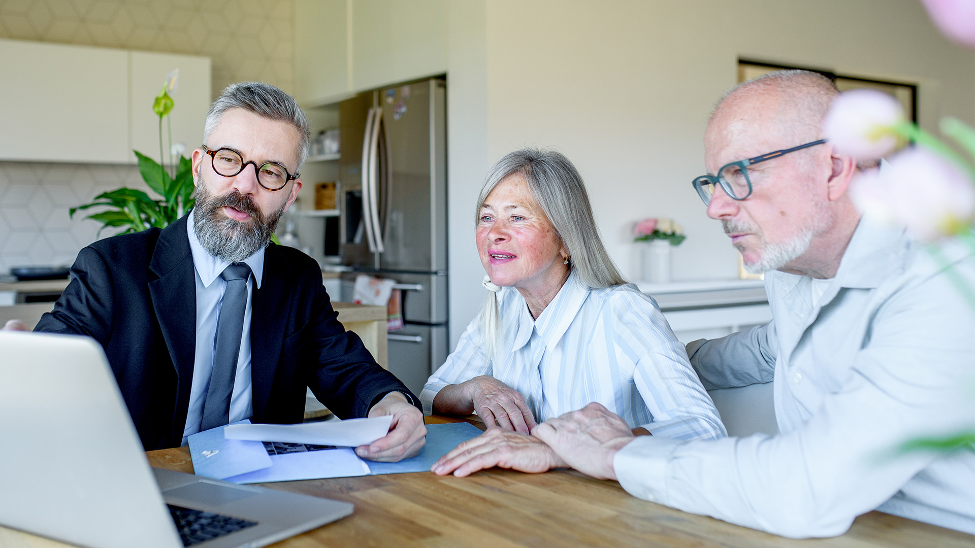 Middle aged advisor meeting with retiree couple