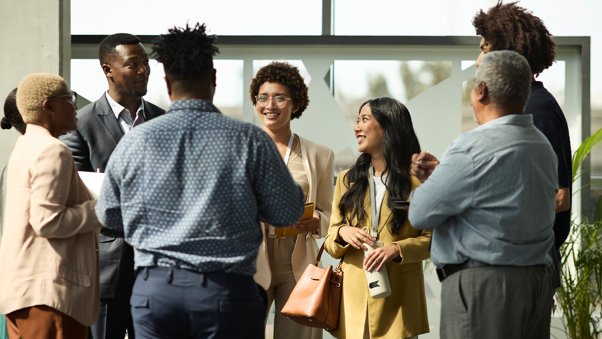 Diverse group of young professional standing in a circle talking