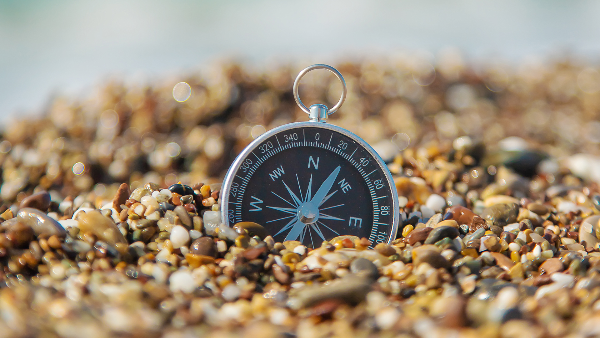 Compass sitting in a bed of rocks
