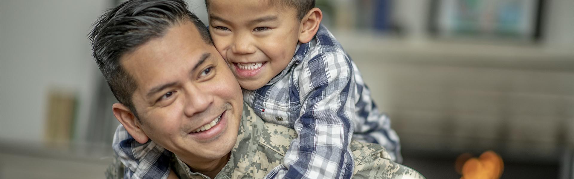 Military dad and his son playing