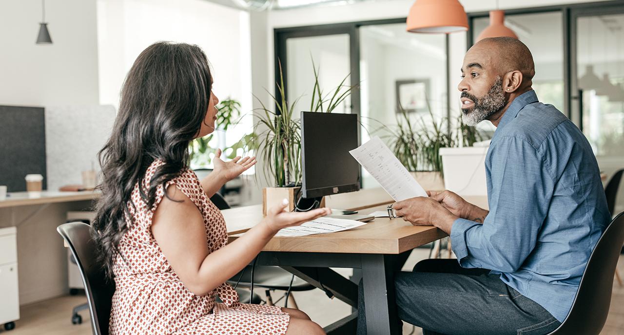 Two work colleagues speaking together