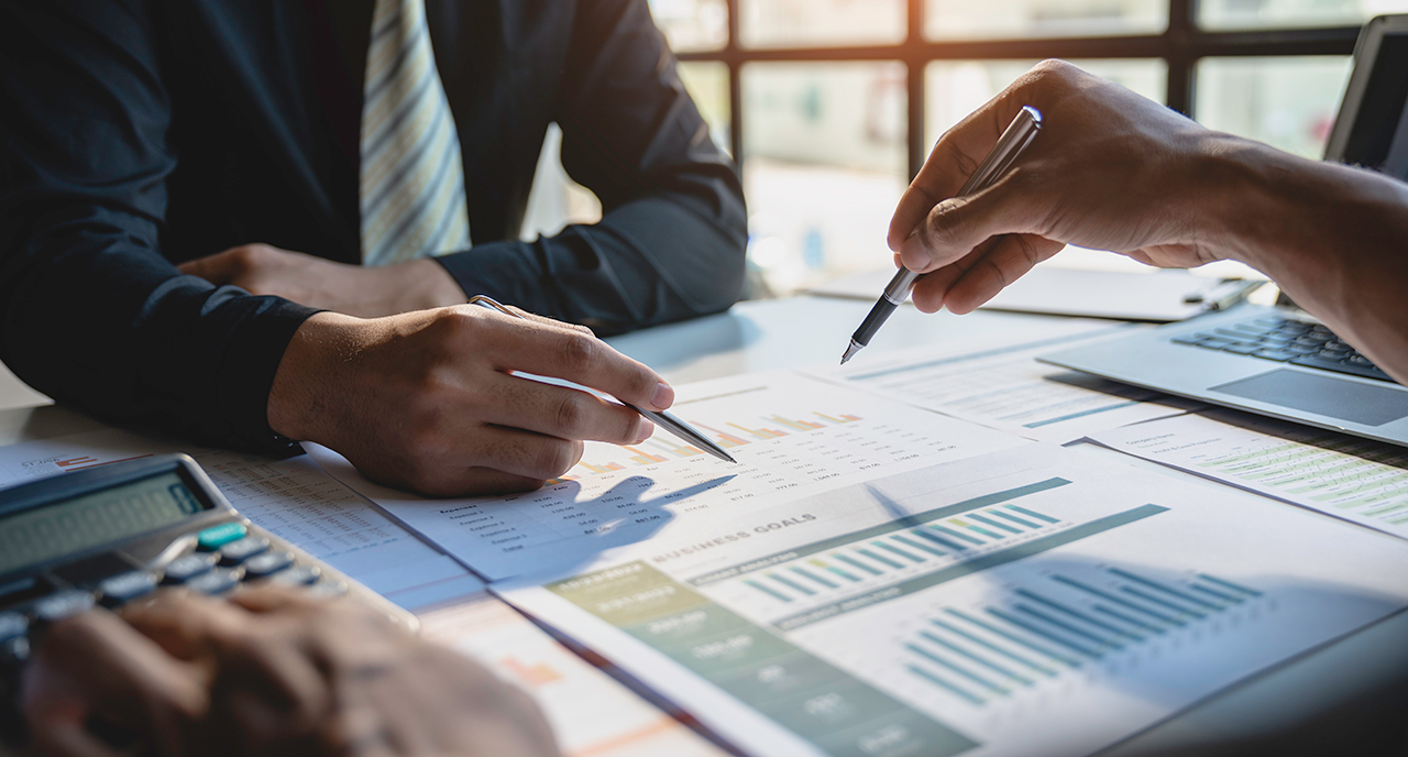 Group of financial advisors working on a spreadsheet together