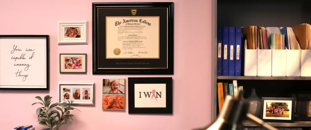 The American College CAP certificate hanging on office wall