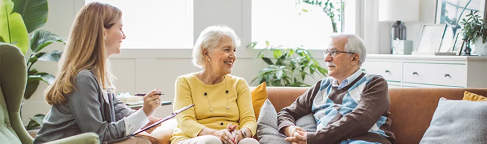 Elderly couple discussing needs with an advisor