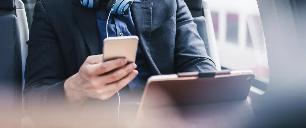 Man looking at a phone and tablet