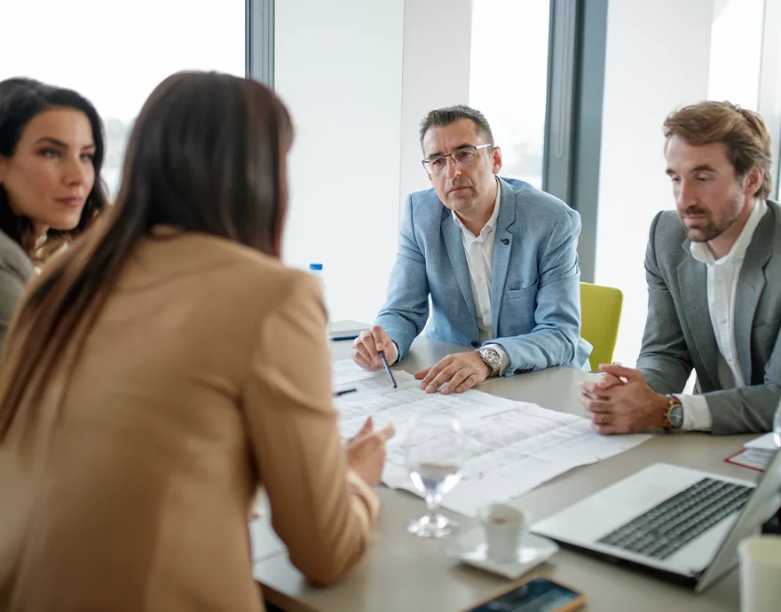 A meeting of 4 people around a table