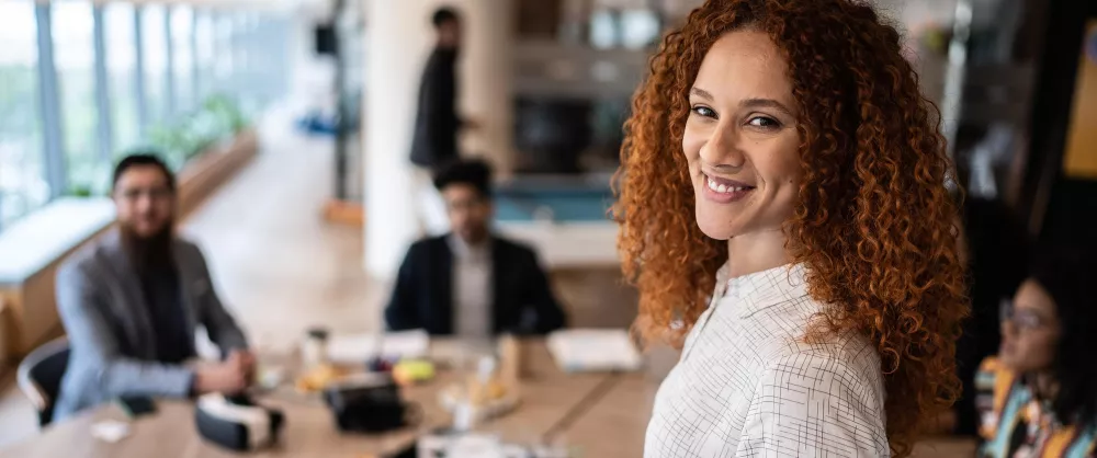 A woman standing in front of a meeting