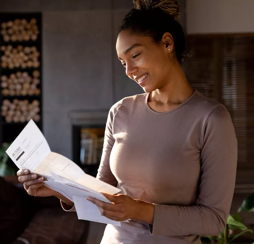 A woman looking at a letter 