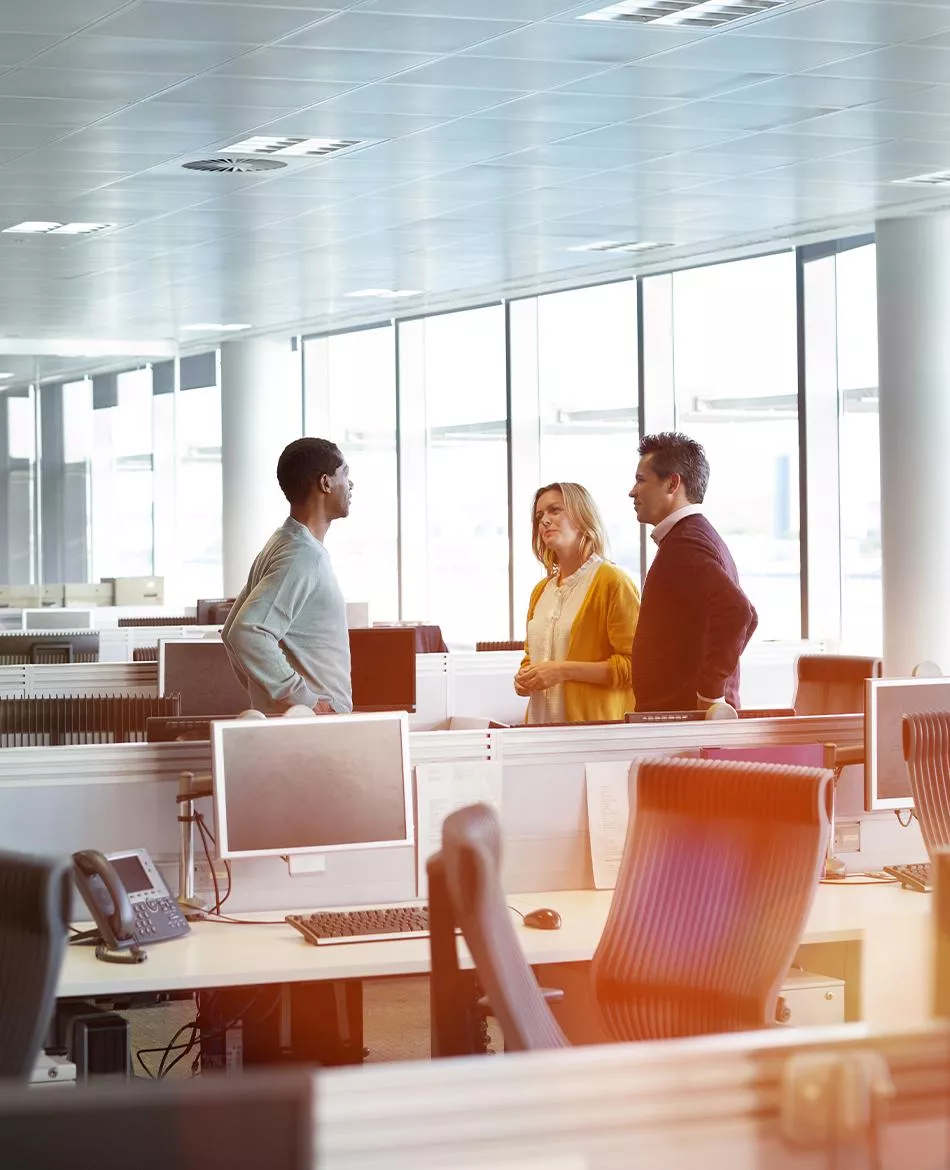 Three people talking in an office