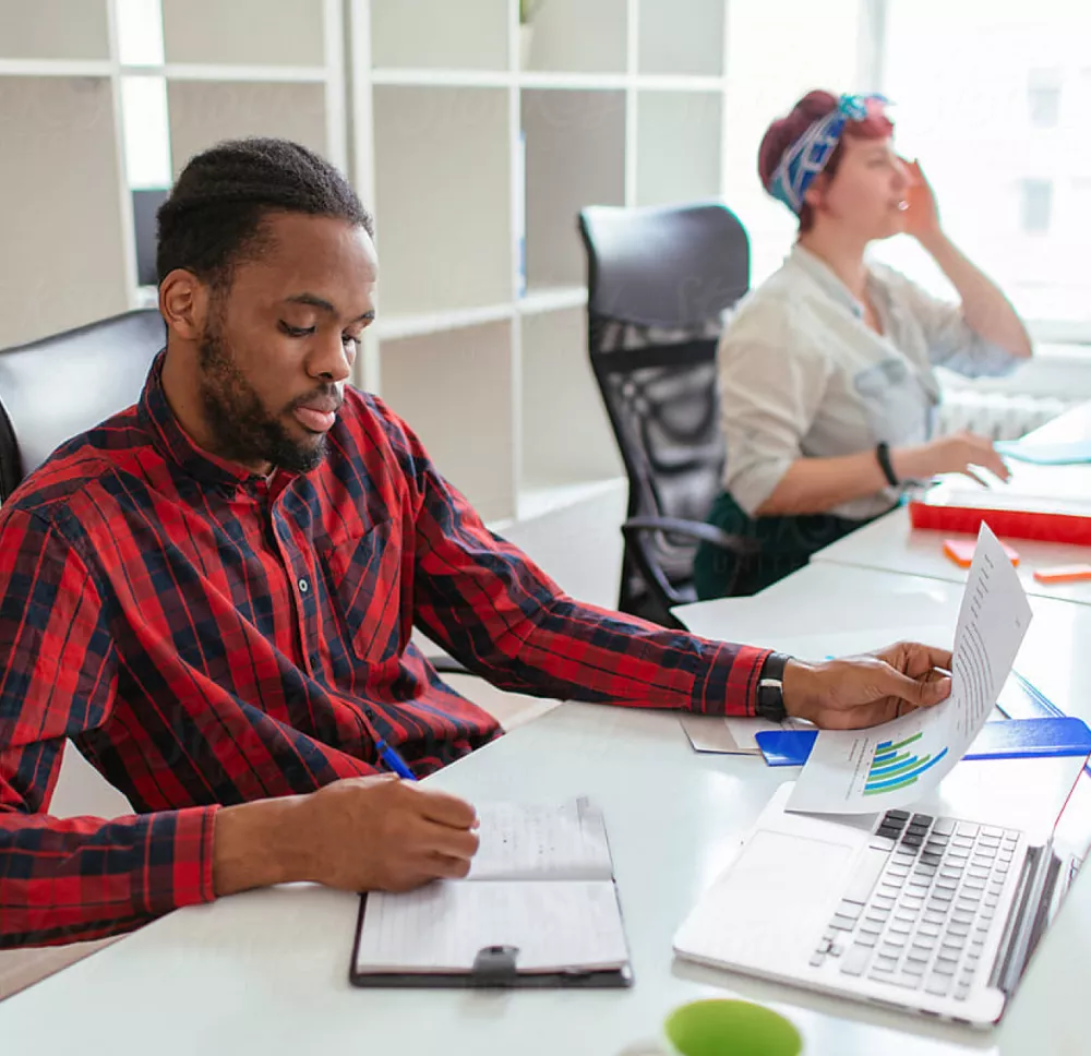 People sitting at desk reviewing financial statements.