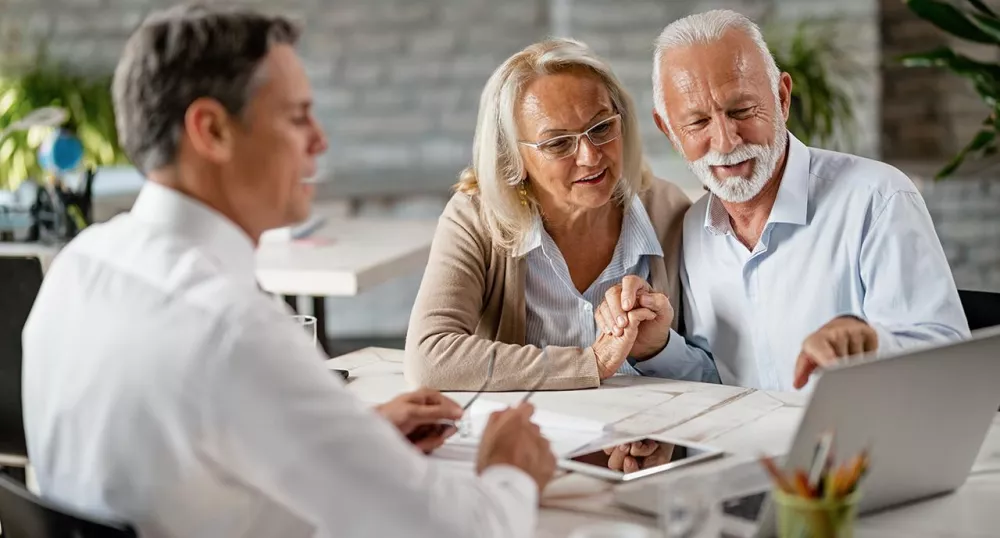 Retirement professional helping an elderly couple plan