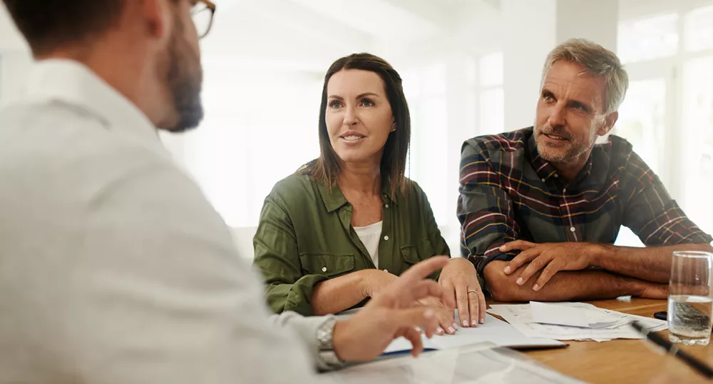 A couple speaking with an advisor about retirement options