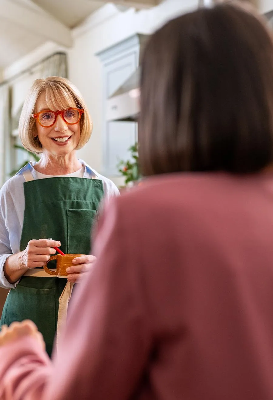Elderly female smiling with an kitchen apron on