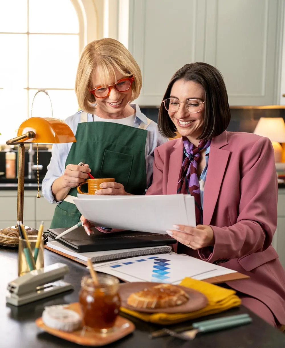 Elderly female and her financial advisor meeting in the kitchen
