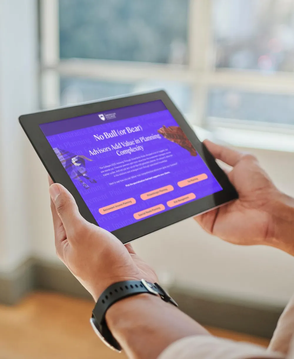 Man holding and looking at a tablet 