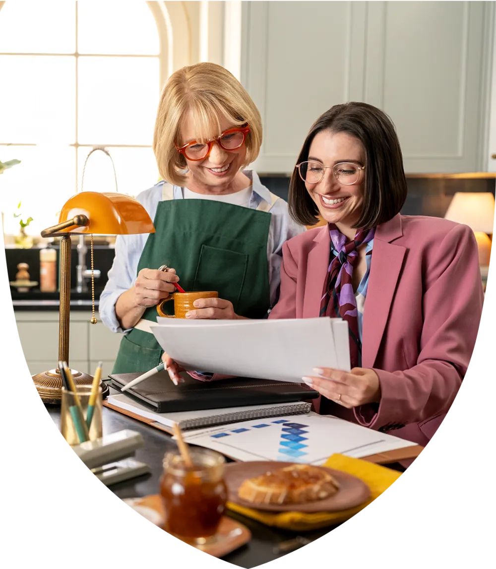 Elderly woman meeting with her advisor in the kitchen