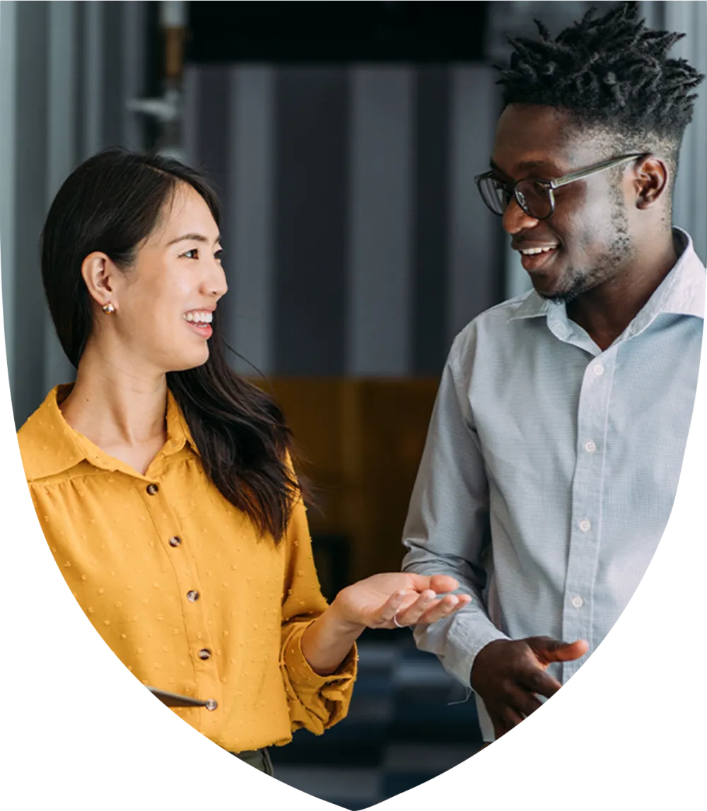 Middle aged male and female professionals smiling and talking together