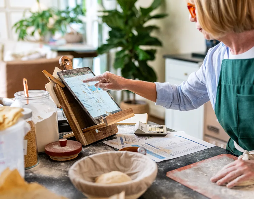 Elderly woman reading a recipe in her kitchen