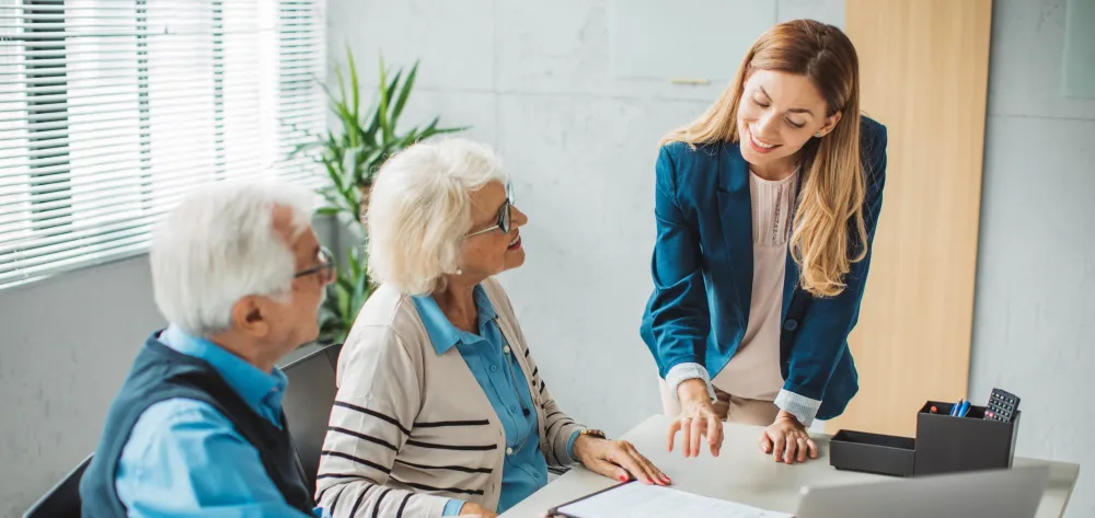 Female advisor speaking with her elderly clients