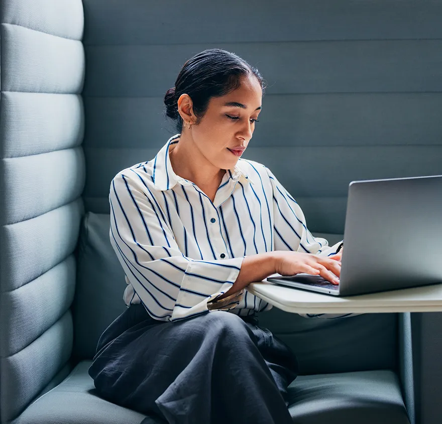 Woman in her early 40's studying for an exam on her laptop