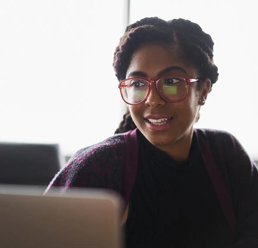 Young female professional smiling with glasses on
