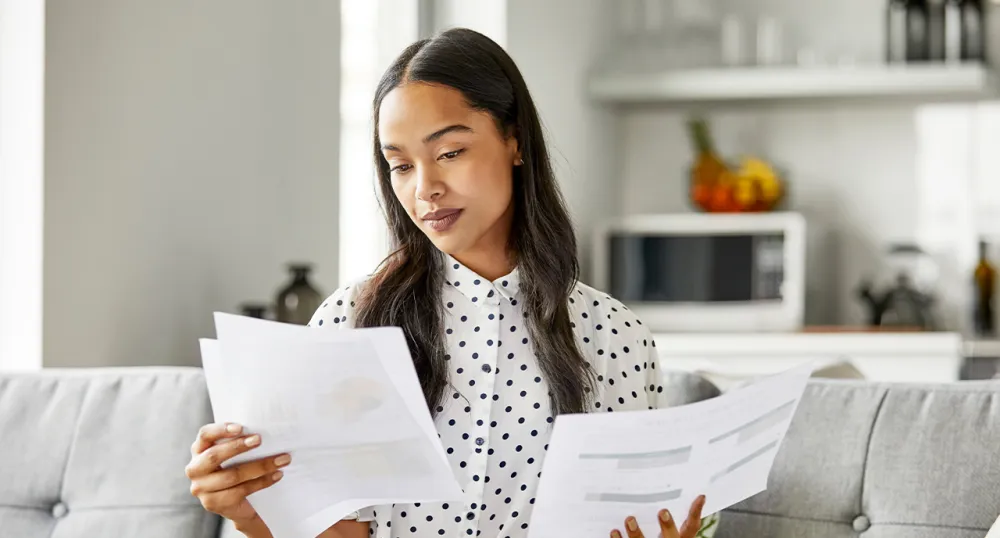 Young female professional reading various reports