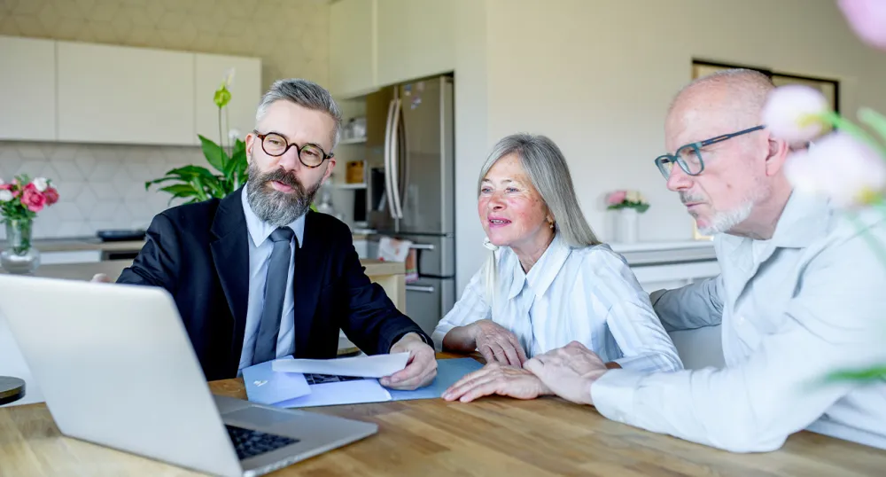 Middle aged advisor meeting with retiree couple