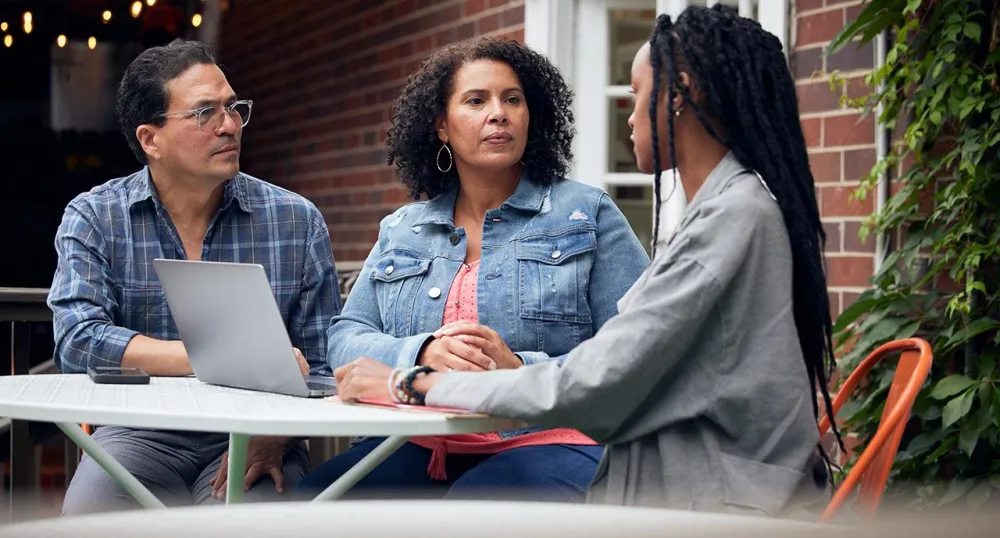 Parents talking with their daughter at the table
