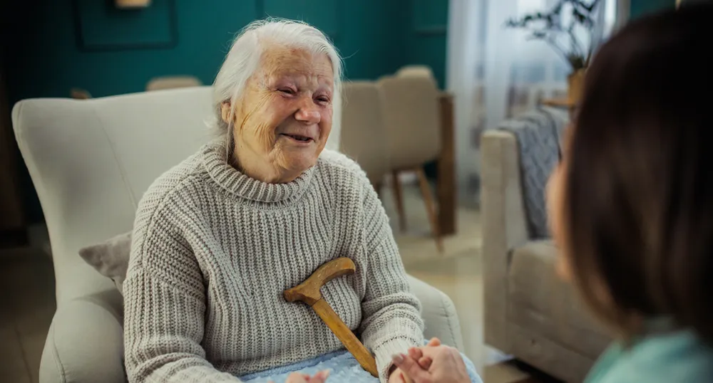 Elderly retired woman smiling in bed