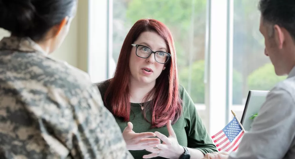 Female advisor meeting with a military service couple