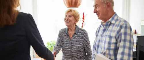 Elderly couple discussing retirement options with an RICP