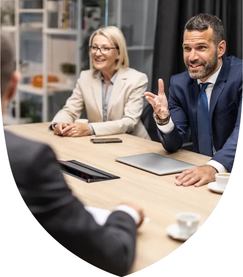 A middle aged male and female professional talking with collegues