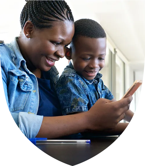 Mom and son looking at phone together smiling
