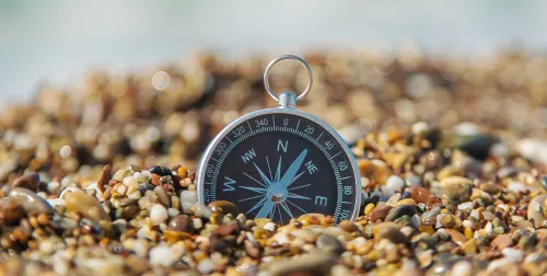 Compass sitting in a bed of rocks