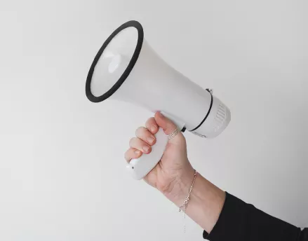 Hand holding megaphone