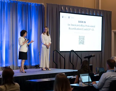 Speakers on stage at a conference