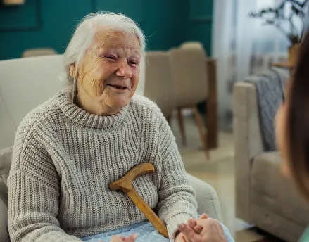 Elderly retired woman smiling in bed
